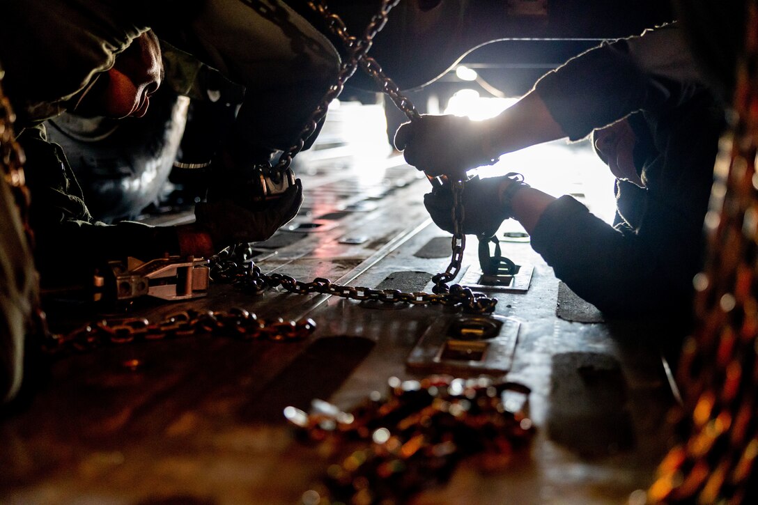 U.S. Marine Corps Staff Sgt. Lance Orticke (left) and Sgt. Joshua Abbott (right), Fixed-Wing Aircraft Loadmasters with Marine Aerial Refueler Transport Squadron (VMGR) 234, Marine Aircraft Group 41, 4th Marine Aircraft Wing, Marine Forces Reserve, finish onloading M142 High Mobility Artillery Rocket System (HIMARS) onto a C-130J Hercules during a HIMARS Rapid Infiltration, also known as a HIRAIN, with Fox Battery, 2nd Battalion, 14th Marine Regiment, 4th Marine Division, Marine Forces Reserve during exercise Arctic Edge 2024 at Eielson Air Force, Alaska, Feb. 24, 2024. The HIRAIN training demonstrated Marine Forces Reserve’s ability to rapidly deploy the HIMARS to meet and deter any threats in any environment, including harsh arctic environments. Arctic Edge 2024 (AE24) is a U.S. Northern Command-led homeland defense exercise demonstrating the U.S. military’s capabilities in extreme cold weather, joint force readiness, and U.S. military commitment to mutual strategic security interests in the arctic region. (U.S. Marine Corps photo by Lance Cpl. Madisyn Paschal)