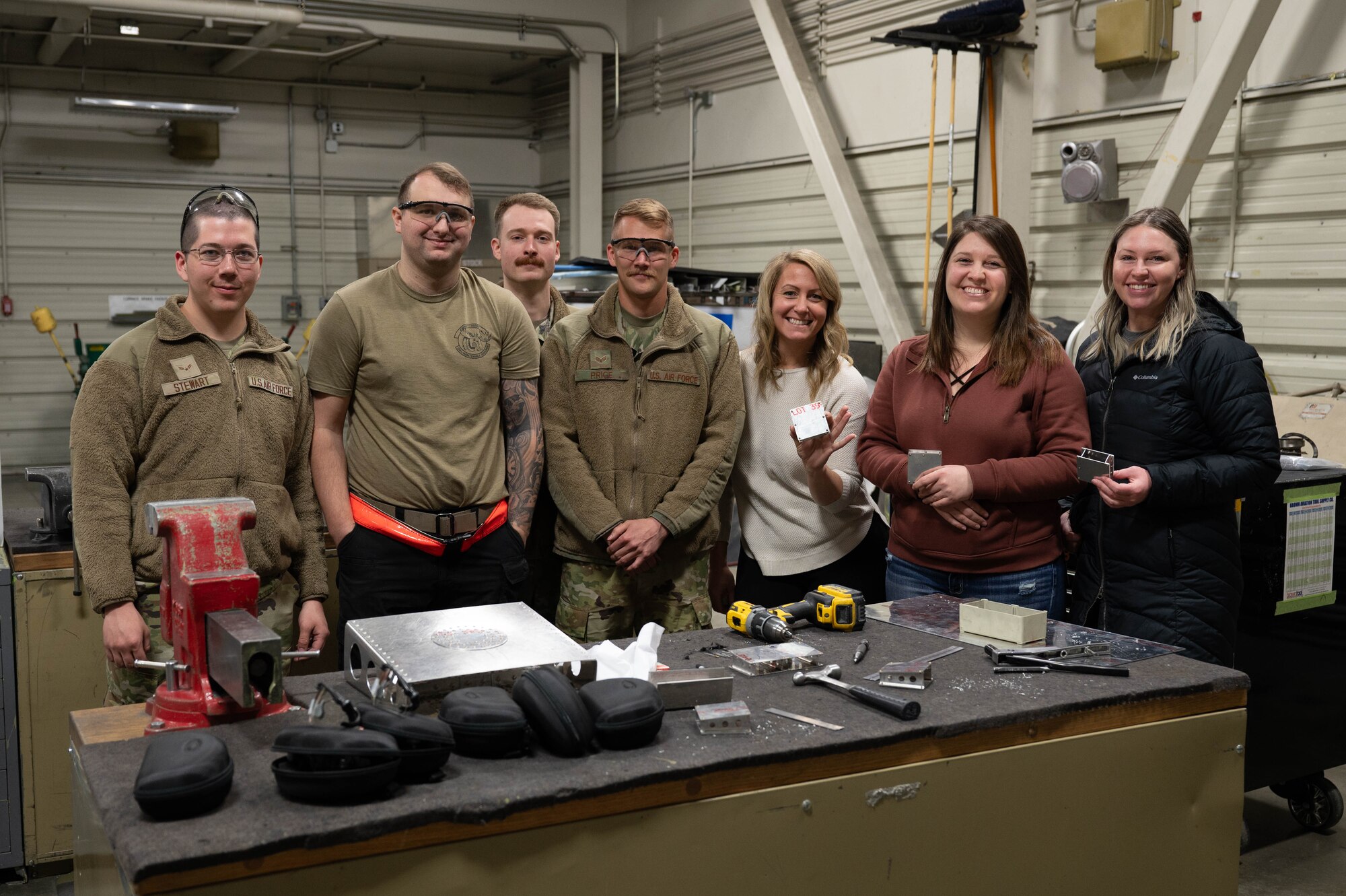 Airmen from the 354th Maintenance Squadron fabrication flight pose for a group photo with 354th MXS spouses during the open house March 1, 2024 Eielson Air Force, Alaska.