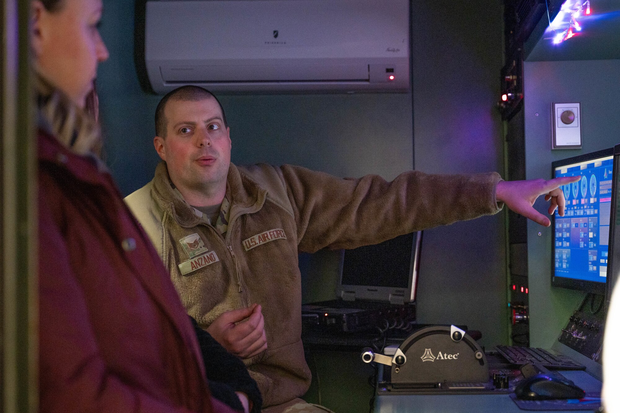 U.S. Air Force Technical Sgt. Rocco Anzano, 354th Maintenance Squadron propulsion flight, briefs a 354th MXS spouse during the spouses' open house March 1, 2024 at Eielson Air Force Base, Alaska.