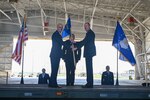 Members of the 433rd Airlift Wing stand at attention during the playing of the U.S. Air Force song during an assumption of command ceremony at Joint Base San Antonio-Lackland, Texas, March 2, 2024