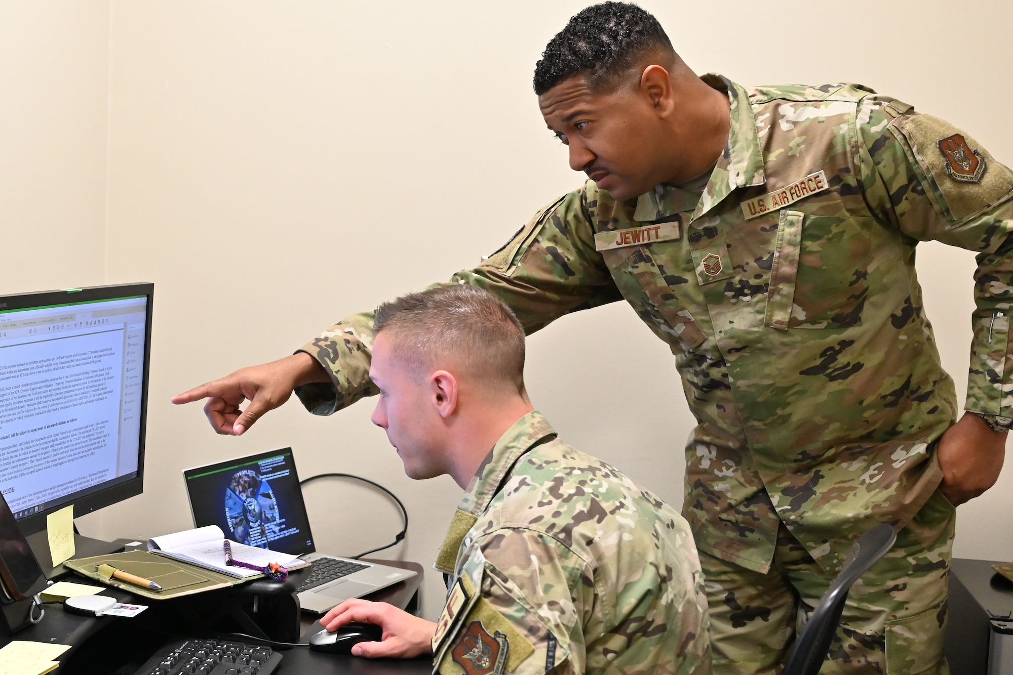 307 BW Talent Management Consultant, Master Sgt. Gavilan Jewitt assists an Airman through their reenlistment incentive paperwork on the computer.