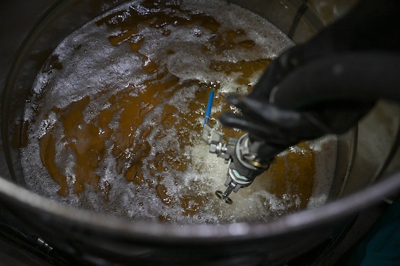 Residual fuel is drained into a container at the Underground Pump House located on Joint Base Pearl Harbor-Hickam (JBPHH), Hawaii, March 4, 2024, where personnel are preparing to disconnect the Red Hill Bulk Fuel Storage Facility (RHBFSF) from the Underground Pump House.