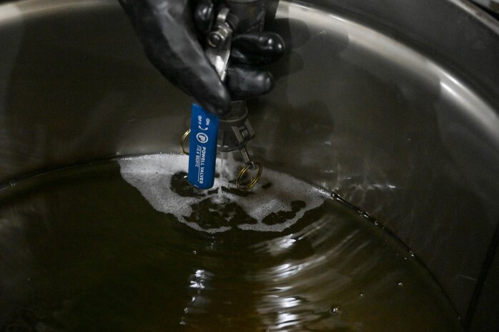Residual fuel is drained into a container at the Underground Pump House located on Joint Base Pearl Harbor-Hickam (JBPHH), Hawaii, March 4, 2024, where personnel are preparing to disconnect the Red Hill Bulk Fuel Storage Facility (RHBFSF) from the Underground Pump House.