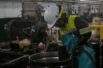 A member in support of Joint Task Force-Red Hill (JTF-RH) guides a drainage line into a fuel drum to remove residual fuel from the Underground Pump House located on Joint Base Pearl Harbor-Hickam (JBPHH), Hawaii, March 4, 2024, where personnel are preparing to disconnect the Red Hill Bulk Fuel Storage Facility (RHBFSF) from the Underground Pump House.