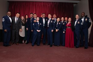 A group of award winners pose for a photo.