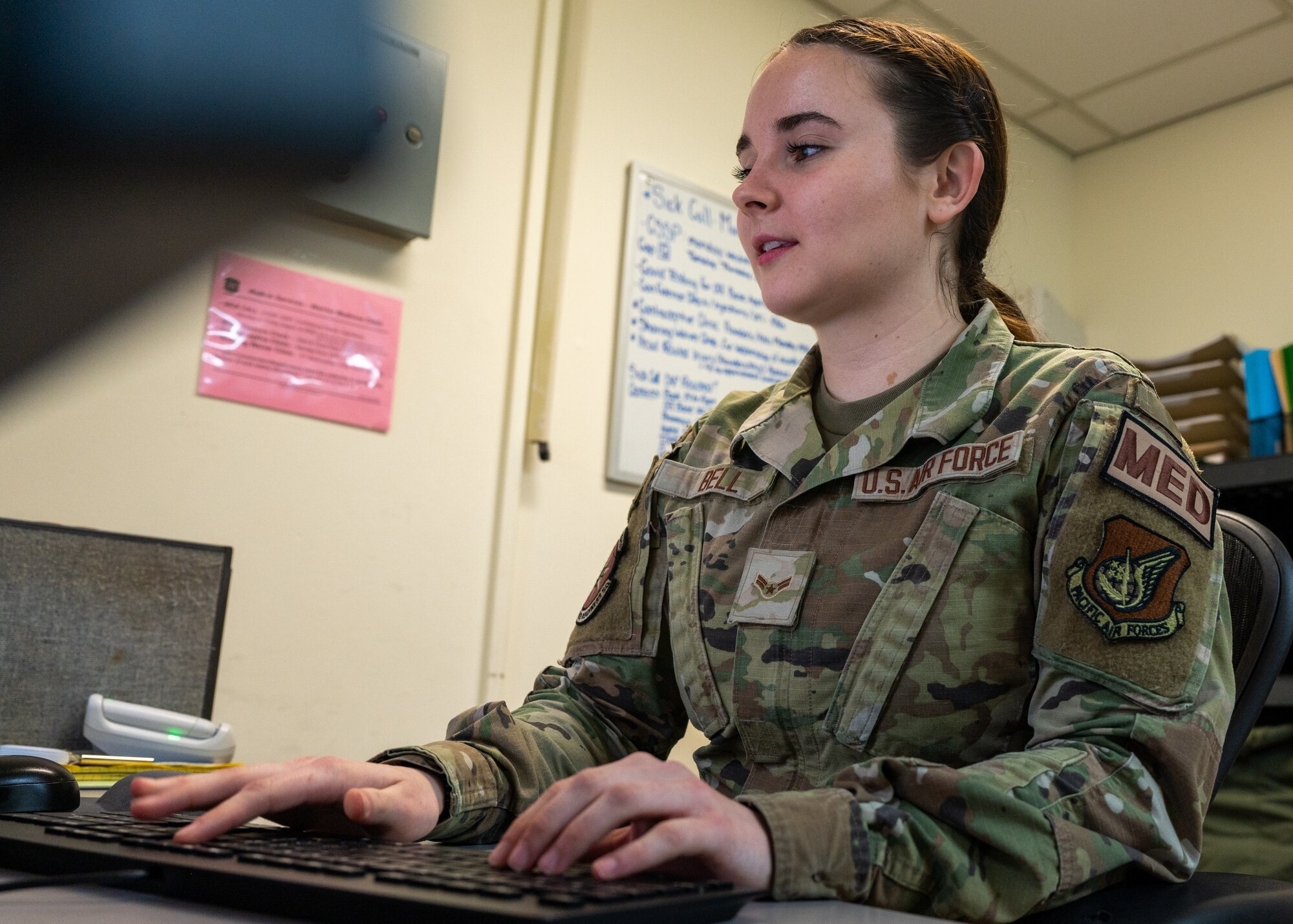 Airmen 1st Class Gabriella Bell schedules a patient for an appointment.