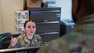 Airmen 1st Class Gabriella Bell welcomes a patient to the 8th Medical Group building.