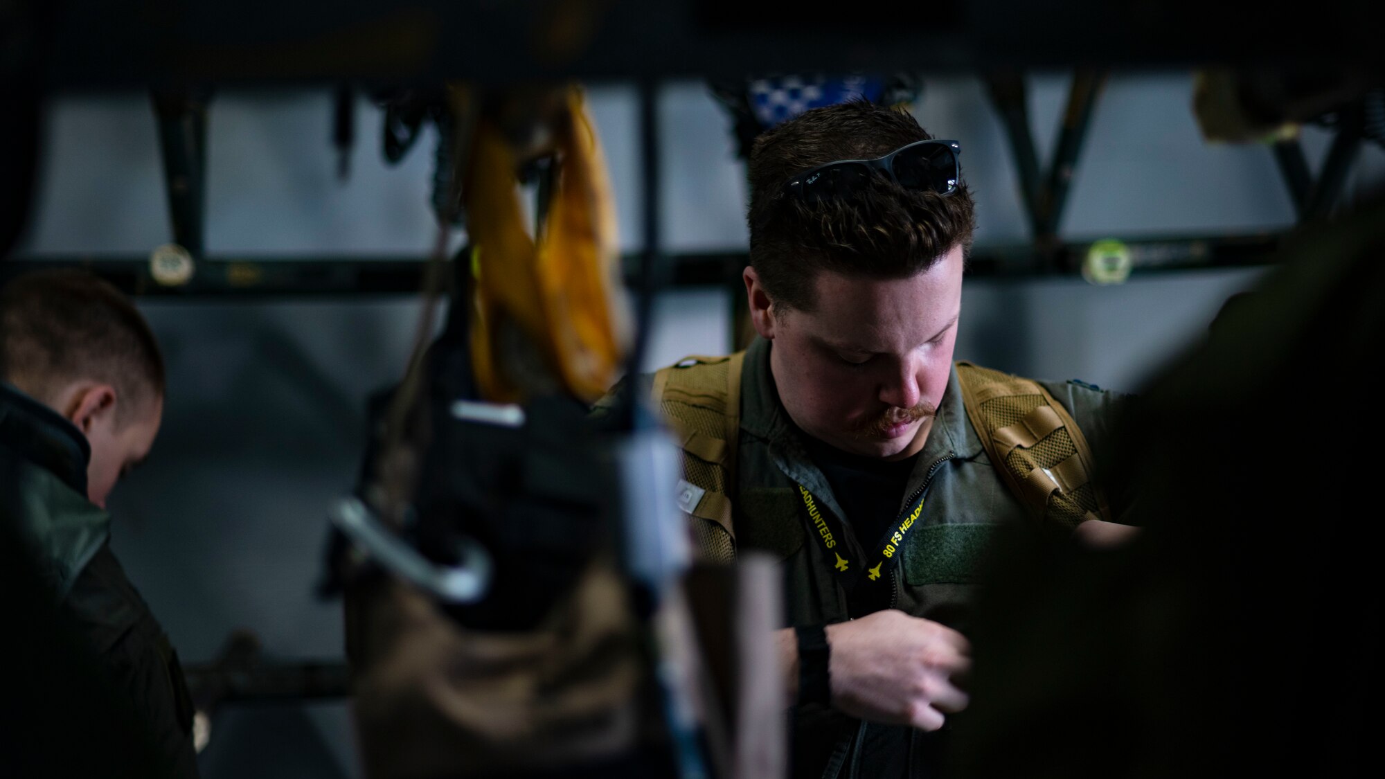 An F-16 Fighting Falcon pilot, dons flight gear before leading U.S. Air Force integration for an amphibious assault exercise