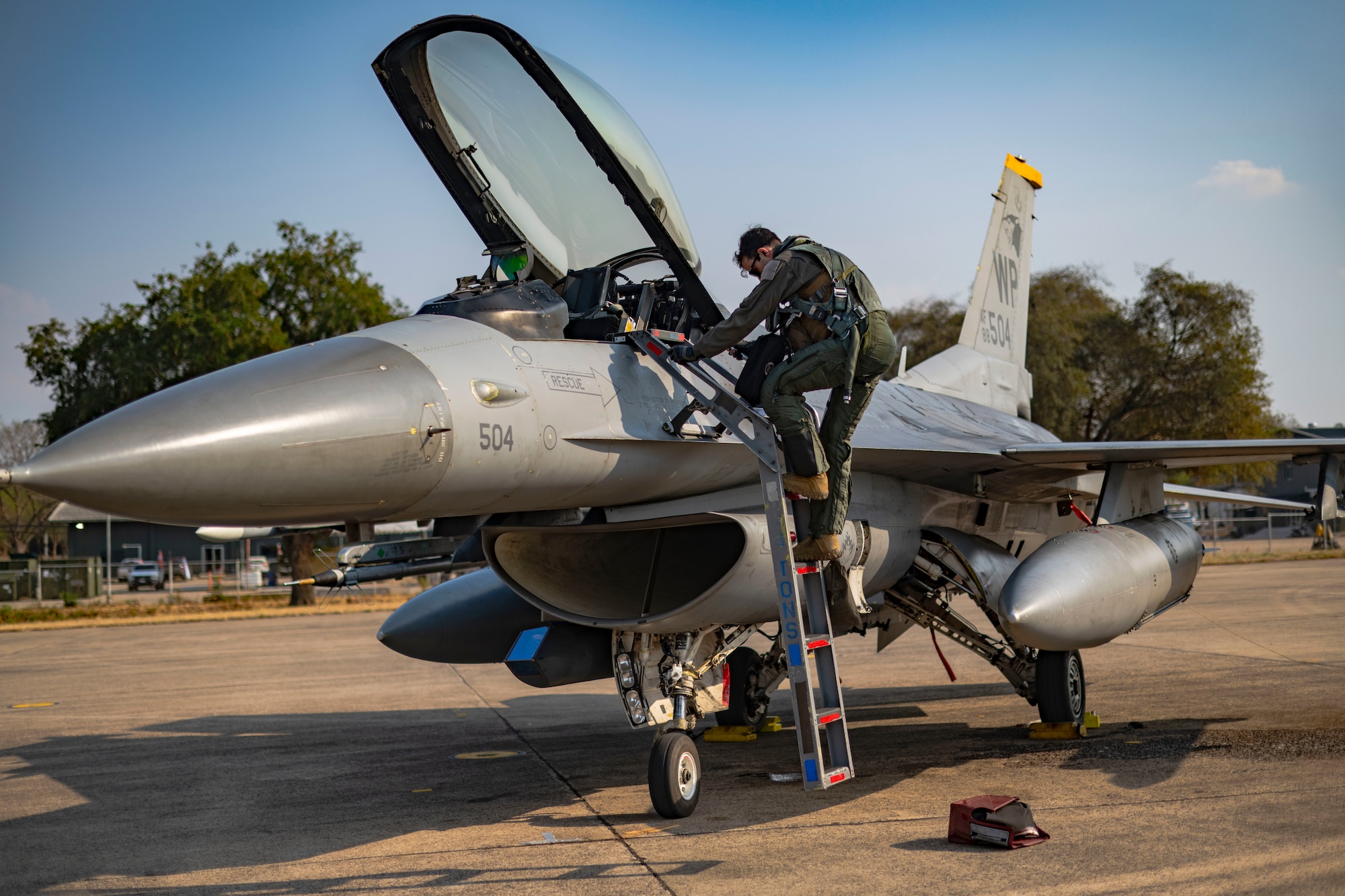 F-16 Fighting Falcon pilot, disembarks an F-16 upon arrival from a multinational maritime strike training scenario