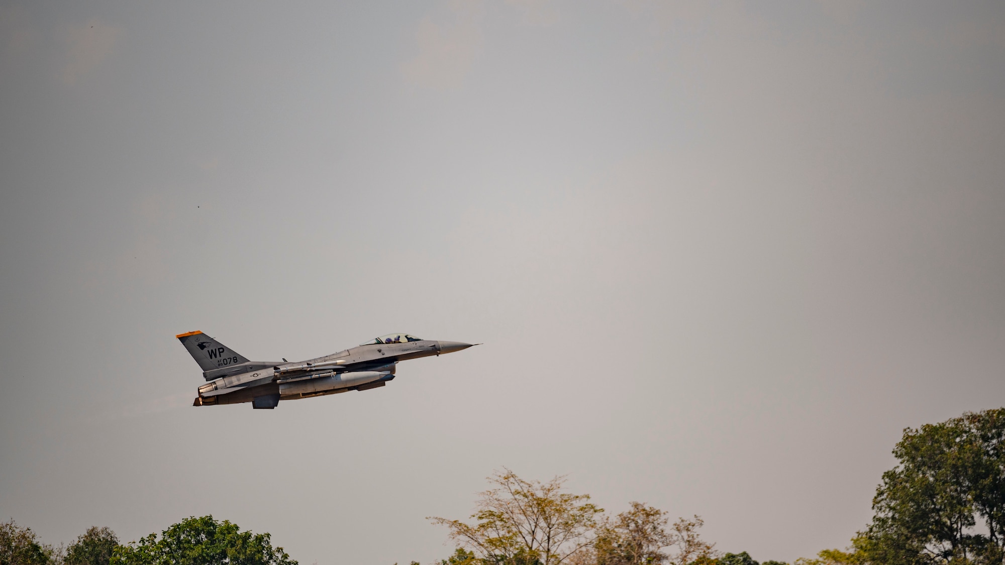 An F-16 Fighting Falcon takes off to participate in a maritime strike exercise scenario
