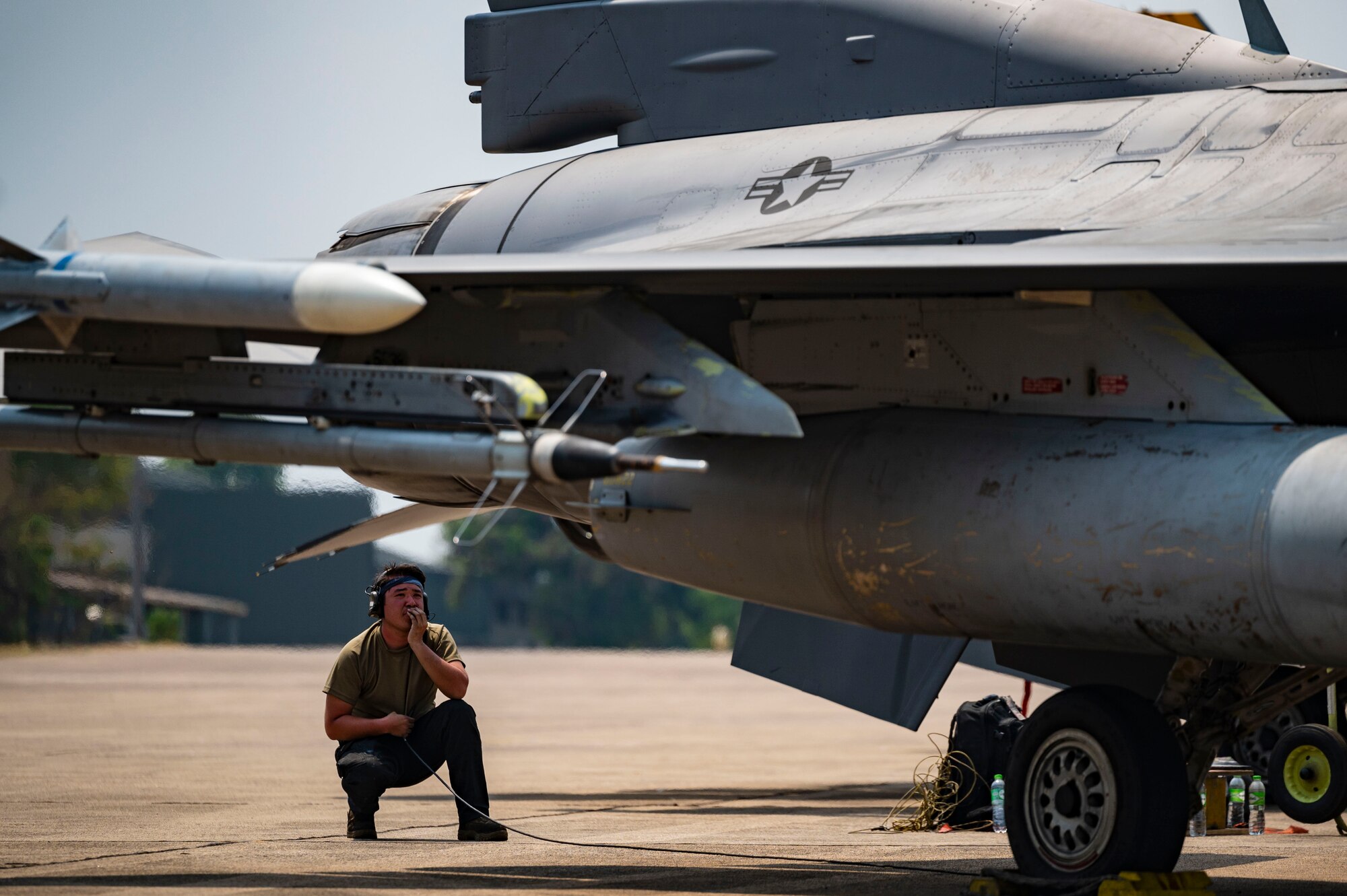 A dedicated crew chief, performs preflight procedures for an F-16 Fighting Falcon