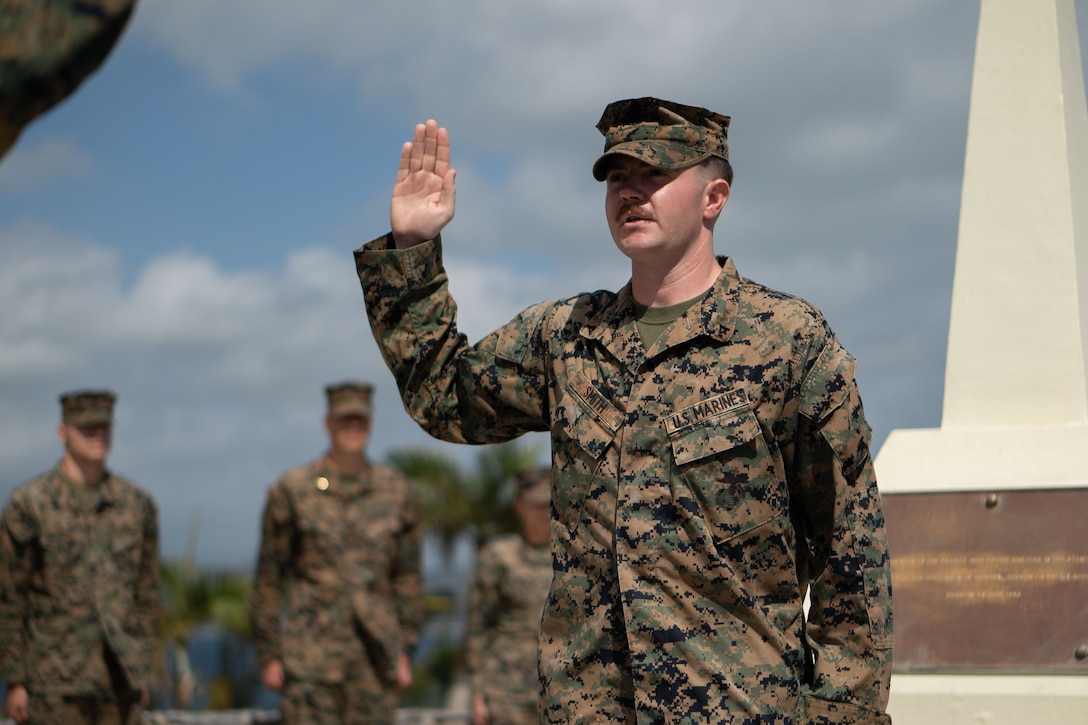 U.S. Marine Corps Lance Cpl. Kaydan N. Smith reenlists during a ceremony on Camp Courtney, Okinawa, Japan, Feb. 21, 2024. Smith said he reenlisted for the Marines around him and for the stability the military provides. “This is my family away from my family,” said Smith. Marines who are eligible for reenlistment demonstrate dedication to duty, professionalism, and leadership ability. Smith, a native of Kansas, is a network administrator with Headquarters Battalion, 3d Marine Division, Okinawa, Japan. (U.S. Marine Corps photo by Staff Sgt. Albert Carls)
