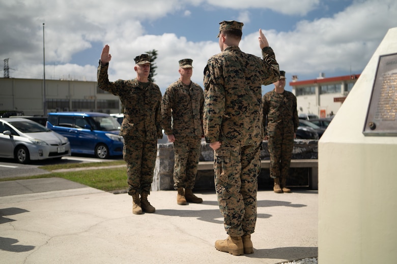 U.S. Marine Corps Maj. Gen. Christian F. Wortman reenlists Lance Cpl. Kaydan N. Smith on Camp Courtney, Okinawa, Japan, Feb. 21, 2024. Smith said he reenlisted for the Marines around him and for the stability the military provides. “This is my family away from my family,” said Smith. Marines who are eligible for reenlistment demonstrate dedication to duty, professionalism, and leadership ability. Smith, a native of Kansas, is a network administrator with Headquarters Battalion, 3d Marine Division, Okinawa, Japan. (U.S. Marine Corps photo by Staff Sgt. Albert Carls)