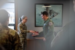 Senior Airman Margaret A. Miller receives a coin from Lt. Gen. Michael A. Loh, director, Air National Guard, at the 128th Air Refueling Wing, Milwaukee, Wisconsin, March 3, 2024. Miller is a part of the 128th ARW medical group and was recognized for exceptional personnel processing that ensured maximum Airmen readiness across the wing.