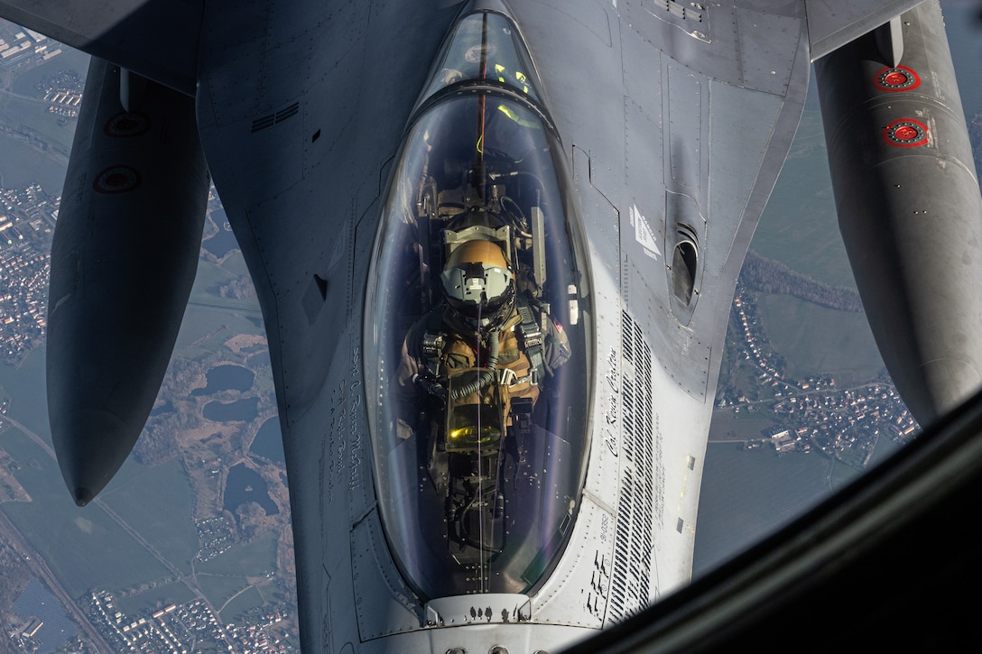 Overhead view of a pilot in a military aircraft that is receiving an in-air refuel.