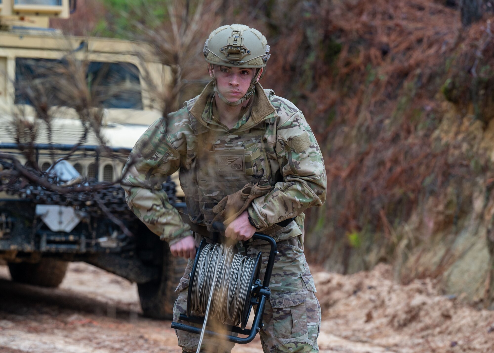 A man holds a reel of rope.