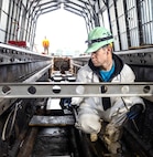 Joshua Fauver, marine machinery mechanic, Shop 38, Marine Machinist, carrier at Puget Sound Naval Shipyard & Intermediate Maintenance Facility in Bremerton, Washington, measures foot pads. (U.S Navy photo by Wendy Hallmark)