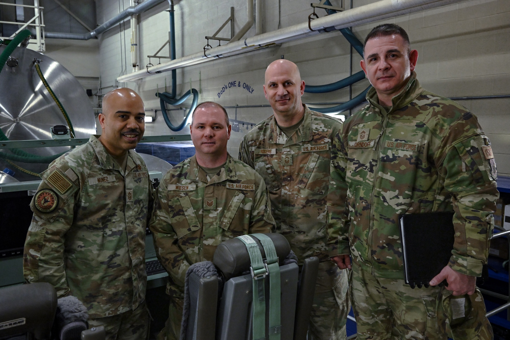 Chief Master Sgt. Israel Nuñez, senior enlisted advisor to the Chief of Air Force Reserve and Command Chief Master Sergeant of Air Force Reserve Command, poses for a photo with 910th Airlift Wing aerial spray maintainers during a base tour at Youngstown Air Reserve Station, Ohio, March 2, 2024.