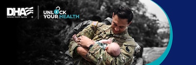 Image of Service Member holding baby in his arms.