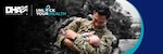 Image of Service Member holding baby in his arms.