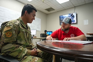 U.S. Air Force Airman Santiago Depablos (left), 97th Logistics Readiness Squadron fleet management and analysis apprentice, reviews a study guide with Thomas Kessler, 97th Logistics Readiness Squadron environmental education and training leader, at Altus Air Force Base, Oklahoma, March 5, 2024. Kessler retired from the Air Force in 2022 as a vehicle fleet manager, and previously held an instructor position at the 344th Training Squadron for vehicle equipment maintenance. (U.S. Air Force photos by Airman 1st Class Kari Degraffenreed)