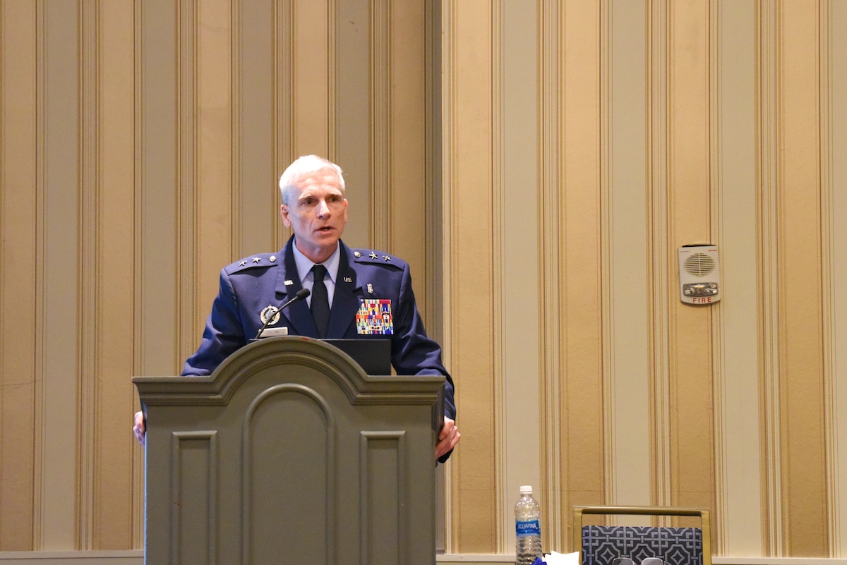 Image of service members speaking at a conference.