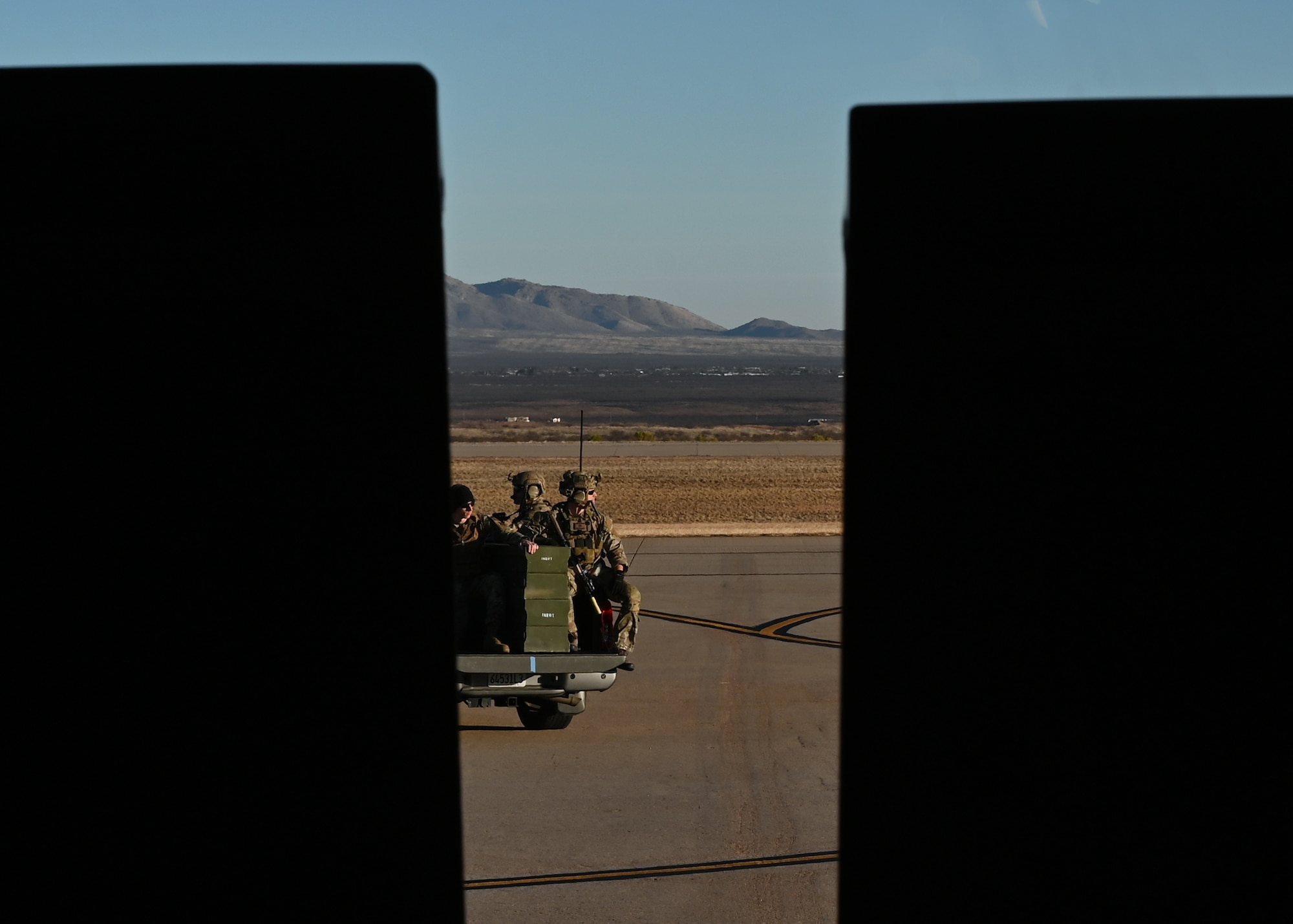 U.S. Airmen assigned to the 48th Rescue Squadron drive unloaded munitions to an unmanned aerial vehicle during Exercise Agile Angel at Fort Huachuca, Ariz., Feb. 20, 2024. The 48th RQS trained in ground tactics to reduce signature in air component operations. (U.S. Air Force photo by Staff Sgt. Abbey Rieves)