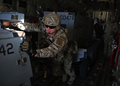 A U.S. Airman assigned to the 48th Rescue Squadron pushes an aircraft generator from an HC-130J Combat King II aircraft during Exercise Agile Angel at Fort Huachuca, Ariz., Feb. 20, 2024. Exercise Agile Angel combined capabilities from four different Air Force Special Warfare specialty codes at a mock contingency location. There, AFSPECWAR teams used physical strength and problem solving skills, should a scenario in the future require a full scale airfield where one does not exist. (U.S. Air Force photo by Staff Sgt. Abbey Rieves)