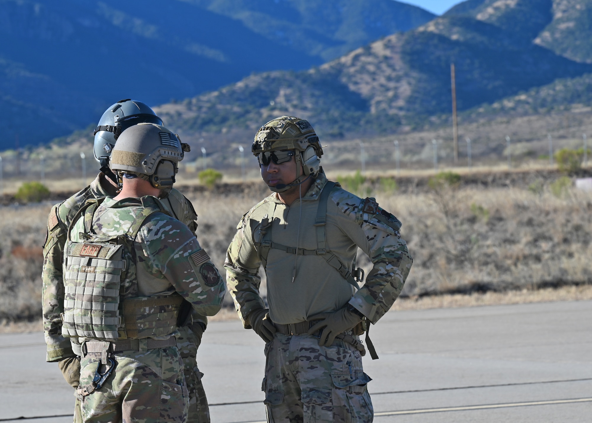U.S. Airmen assigned to the 355th Wing sync plans during Exercise Agile Angel at Fort Huachuca, Ariz., Feb. 20, 2024. These Airmen teamed up with the 48th Rescue Squadron to combined Airmen from combat rescue officer, pararescueman, survival, evasion, resistance and escape and tactical air control party career fields to operate outside of their traditional mission to set up a landing zone, a forward area refueling point, execute and integrated combat turn and re-role personnel recovery operations. (U.S. Air Force photo by Staff Sgt. Abbey Rieves)