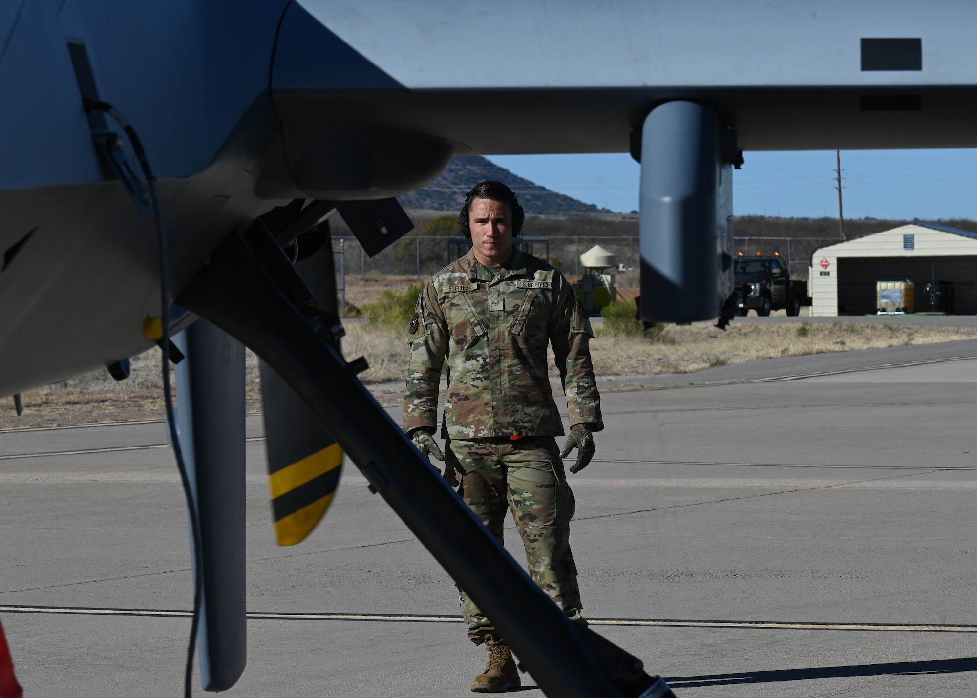 A U.S. Air Force fire protection personnel confirms fire safety of the MQ-9 Reaper unmanned aerial vehicle during Exercise Agile Angel at Fort Huachuca, Ariz., Feb. 20, 2024. Fire protection personnel were specifically trained in aircraft rescue and fire fighting, making them capable on the flight line. (U.S. Air Force photo by Staff Sgt. Abbey Rieves)