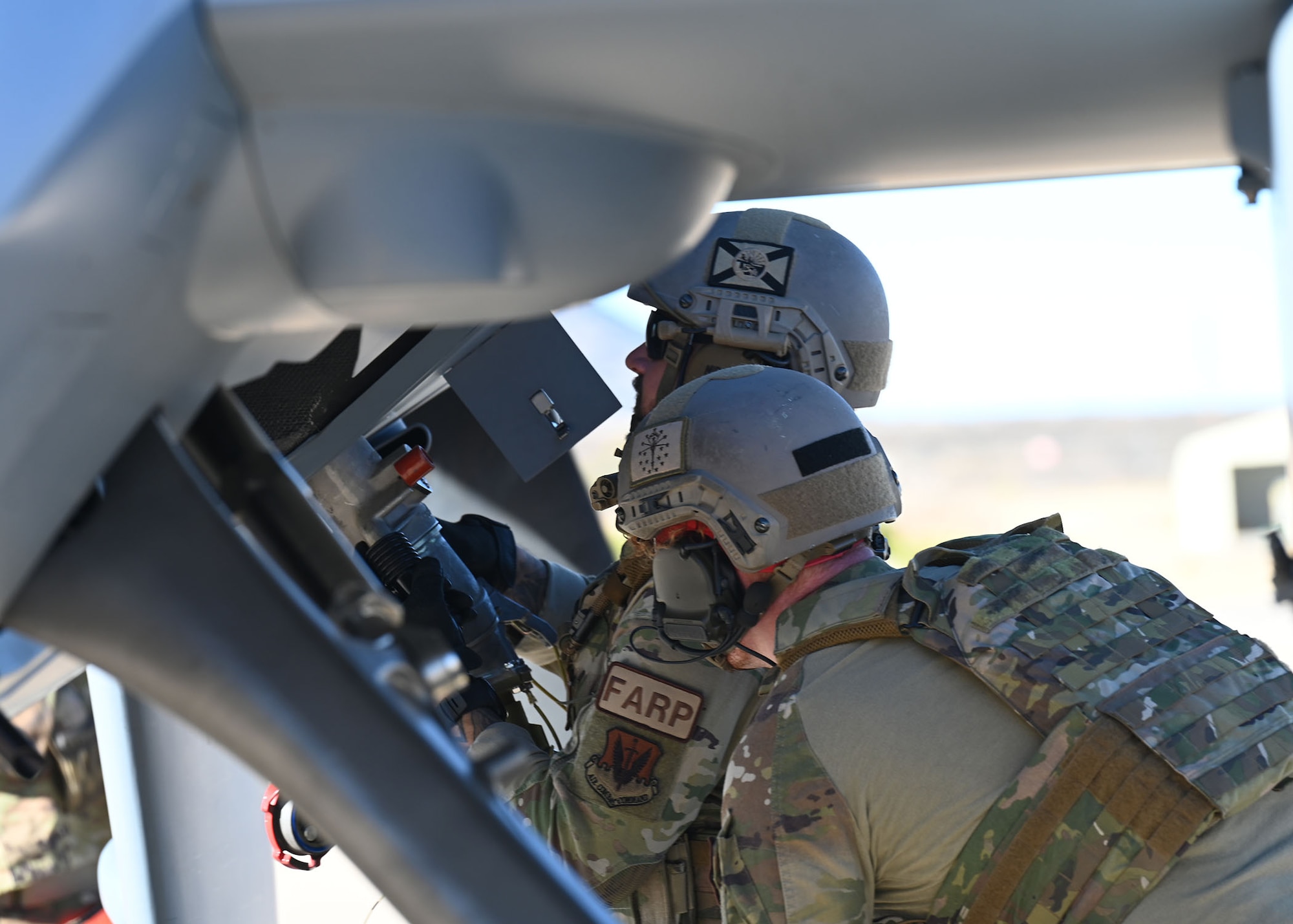 U.S. Air Force Senior Airman Oliver Wendland, right, and Tech. Sgt. Daniel Middaugh, left, 355th Logistics Readiness Squadron forward area refueling point operators, simulated refueling an MQ-9 Reaper unmanned aerial vehicle during Exercise Agile Angel at Fort Huachuca, Ariz., Feb. 20, 2024. FARP can only be conducted by personnel in Air Force specialty code 2F0X1 with a Special Equipment Identifier. (U.S. Air Force photo by Staff Sgt. Abbey Rieves)
