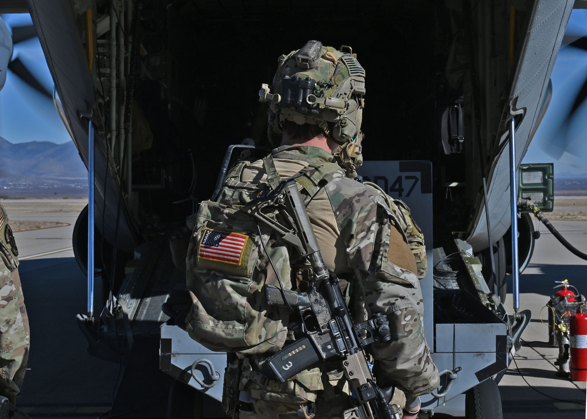 A U.S. Airman assigned to the 48th Rescue Squadron prepares to unload cargo during Exercise Agile Angel at Fort Huachuca, Ariz., Feb. 20, 2024. The 48th RQS demonstrated their comprehensive Airman fitness when they rapidly dispersed, defended the mock contingency location and demonstrated how they generated combat power. (U.S. Air Force photo by Staff Sgt. Abbey Rieves)