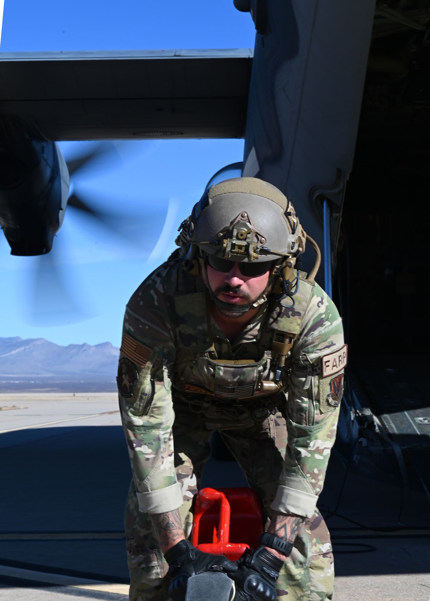U.S. Air Force Tech. Sgt. Daniel Middaugh, 355th Logistics Readiness Squadron forward area refueling point operator, rolls a fuel hose during Exercise Agile Angel at Fort Huachuca, Ariz., Feb. 20, 2024. The fuel hose was approximately 300 feet long. (U.S. Air Force photo by Staff Sgt. Abbey Rieves)