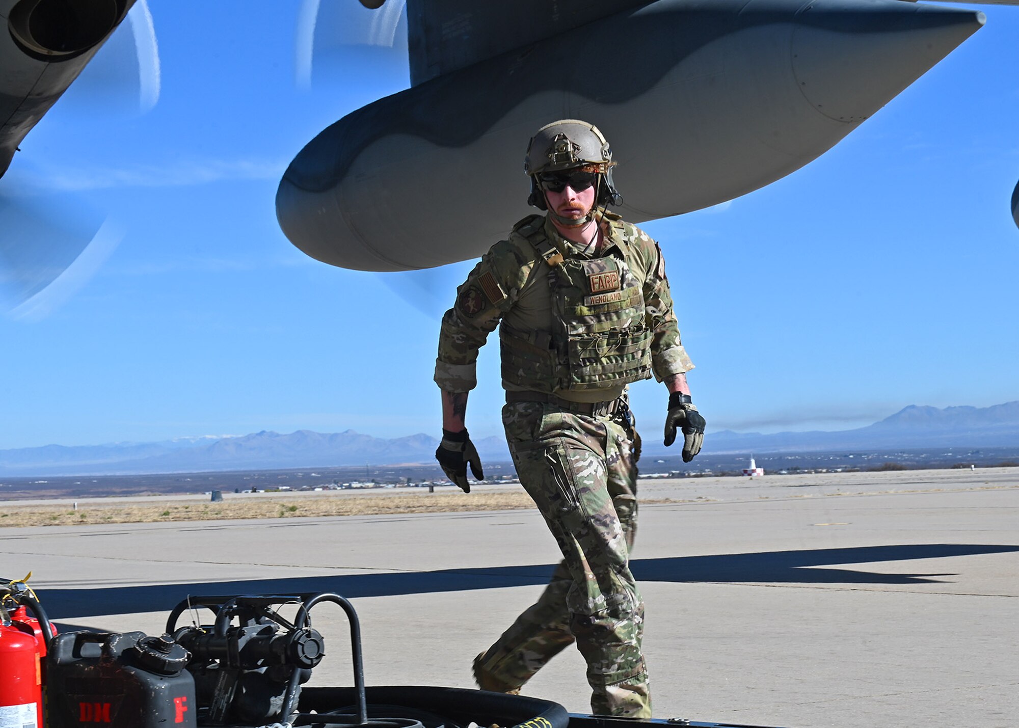 U.S. Air Force Senior Airman Oliver Wendland, 355th Logistics Readiness Squadron forward area refueling point operator,  prepares for FARP during Exercise Agile Angel at Fort Huachuca, Ariz., Feb. 20, 2024. The purpose of FARP operators was to expeditiously transfer fuel from a tanker aircraft into a receiver aircraft, while aircraft engines remain on. (U.S. Air Force photo by Staff Sgt. Abbey Rieves)