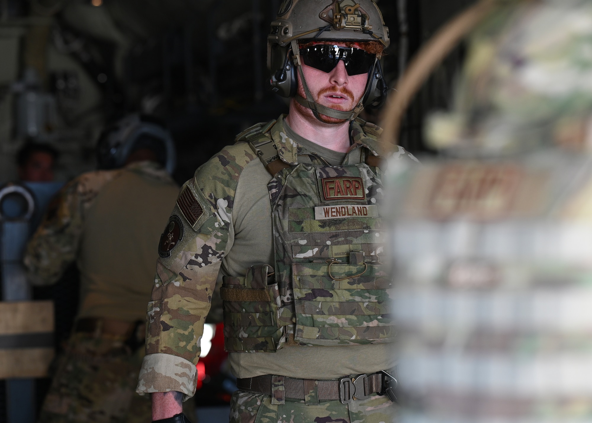 U.S. Air Force Senior Airman Oliver Wendland, 355th Logistics Readiness Squadron forward area refueling point operator, hauls cargo onto an HC-130J Combat King II aircraft during Exercise Agile Angel at Fort Huachuca, Ariz., Feb. 20, 2024. The 355th LRS were subject matter experts and augmented the 48th Rescue Squadron with FARP capabilities during the exercise. (U.S. Air Force photo by Staff Sgt. Abbey Rieves)