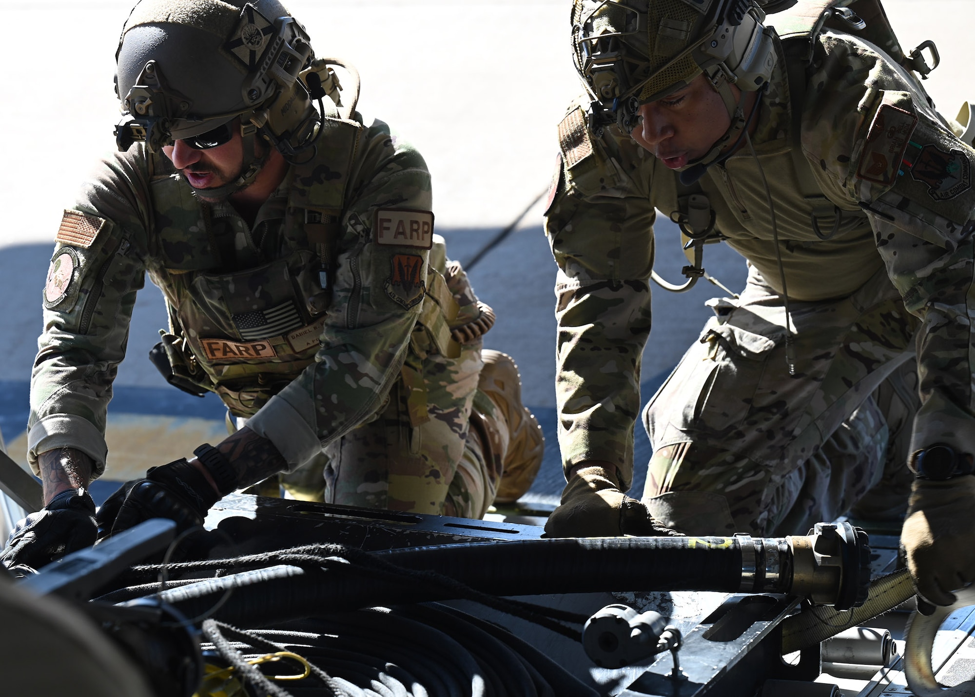 U.S. Air Force Tech. Sgt. Daniel Middaugh, left, 355th Logistics Readiness Squadron forward area refueling point operator, and Master Sgt. Byron Simon, 79th Rescue Squadron loadmaster, secure FARP equipment on an HC-130J Combat King II aircraft during Exercise Agile Angel at Fort Huachuca, Ariz., Feb. 20, 2024. Middaugh and Simon worked together to expedite the operational tempo, which complicates or negates adversary response. (U.S. Air Force photo by Staff Sgt. Abbey Rieves)