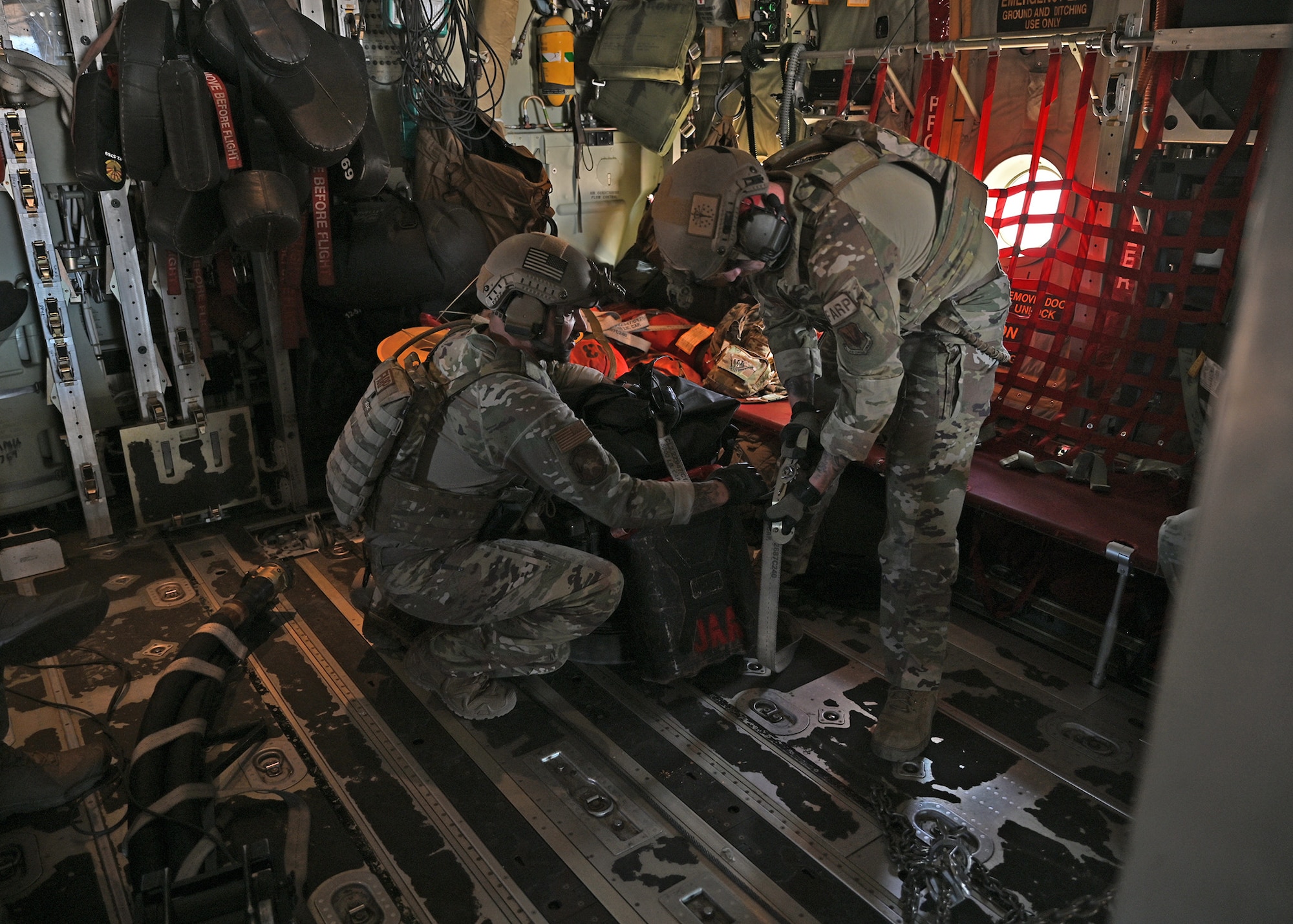 U.S. Air Force Senior Airman Oliver Wendland, right, and Tech. Sgt. Daniel Middaugh, left, 355th Logistics Readiness Squadron forward area refueling point operators, secure cargo for flight during Exercise Agile Angel at Fort Huachuca, Ariz., Feb. 20, 2024. FARP was a mobile refueling point that strengthened pilots’ airpower and lethality by fueling up anywhere an aircraft could land. (U.S. Air Force photo by Staff Sgt. Abbey Rieves)