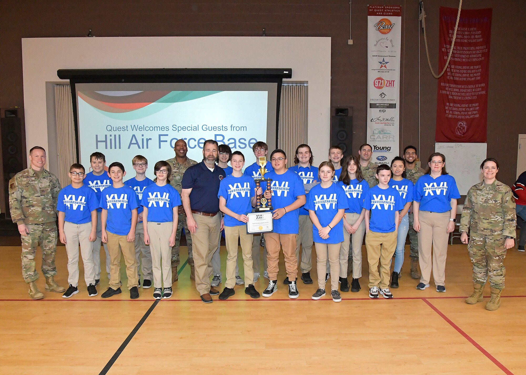Hill Air Force Base leadership present the Air & Space Force Association certificate and school trophy to the Quest Academy Charter School “Cyber Patriot” team March 6, 2024, in West Haven, Utah. The student team recently competed in the National Youth Cyber Defense Competition, the nation's largest that puts middle and high school students in charge of securing a simulated virtual network. The middle school team placed first in the state of Utah this year, which was in the top 11% nationally of the state finals competition and in the top 15% nationally in the national semi-finals.