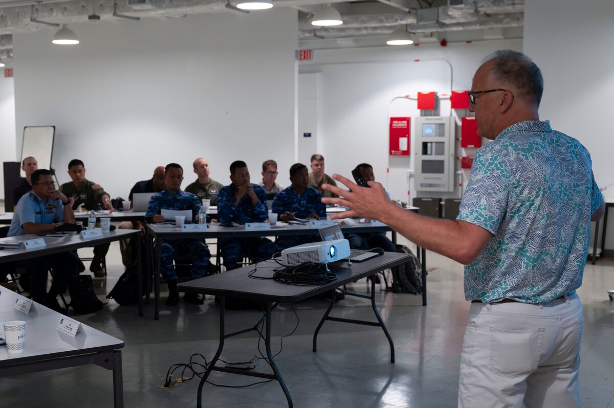 Kevin Palko, briefs participants of the Regional Air Domain Awareness Senior Leader Seminar on Andersen Air Force Base, Guam, Feb. 26, 2024. Throughout the seminar, leaders discussed air domain strategies, policies, terminology and also developed a network of Allies and partners that have a shared understanding of air domain awareness. (U.S. Air Force photo by Airman 1st Class Spencer Perkins)