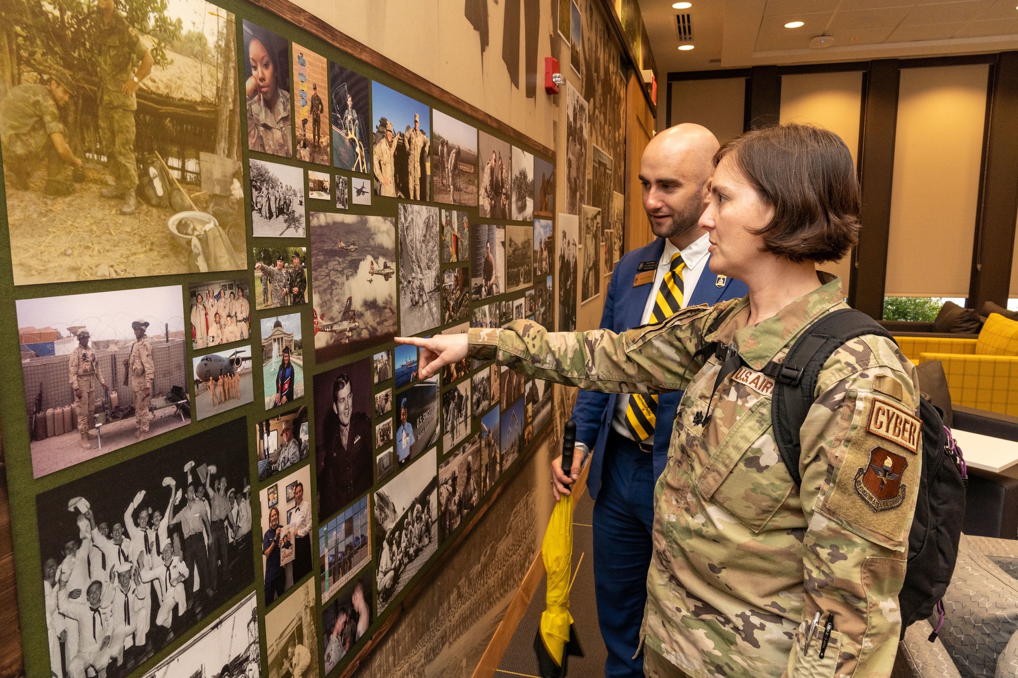 Lt. Col. Jennifer Weller, 336th Training Squadron commander, and Sawyer Walters, University of Southern Mississippi development officer, talk about their military experiences while scan a wall of veterans at USM in Hattiesburg, Mississippi, March 1st, 2024.