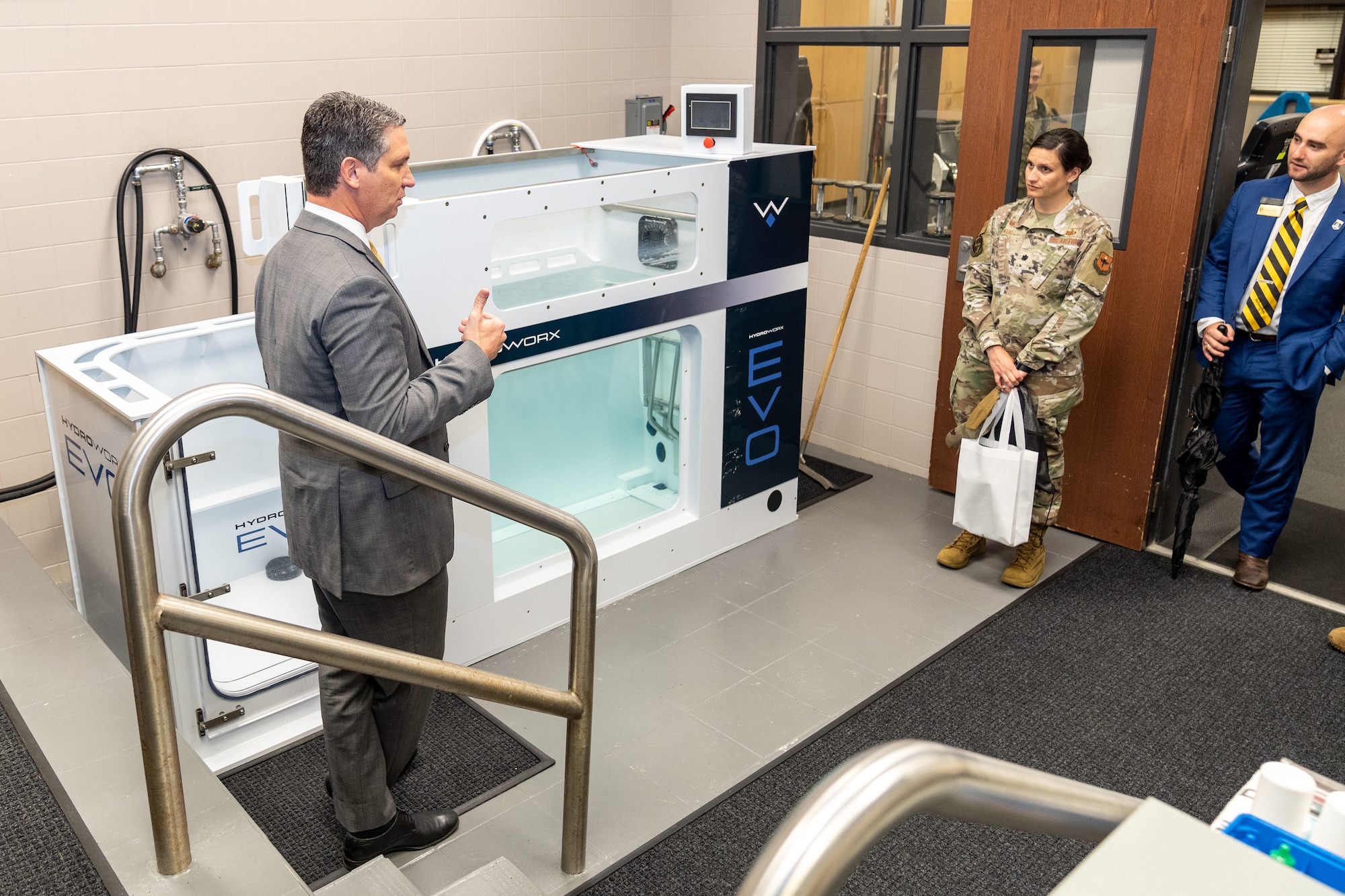 A staff member from the University of Southern Mississippi describes the physical therapy treatments students can receive to Lt. Col. Katherine Kuc, 81st Force Support Squadron commander, and Sawyer Walters, USM development officer, at Hattiesburg, Mississippi, March 1, 2024.