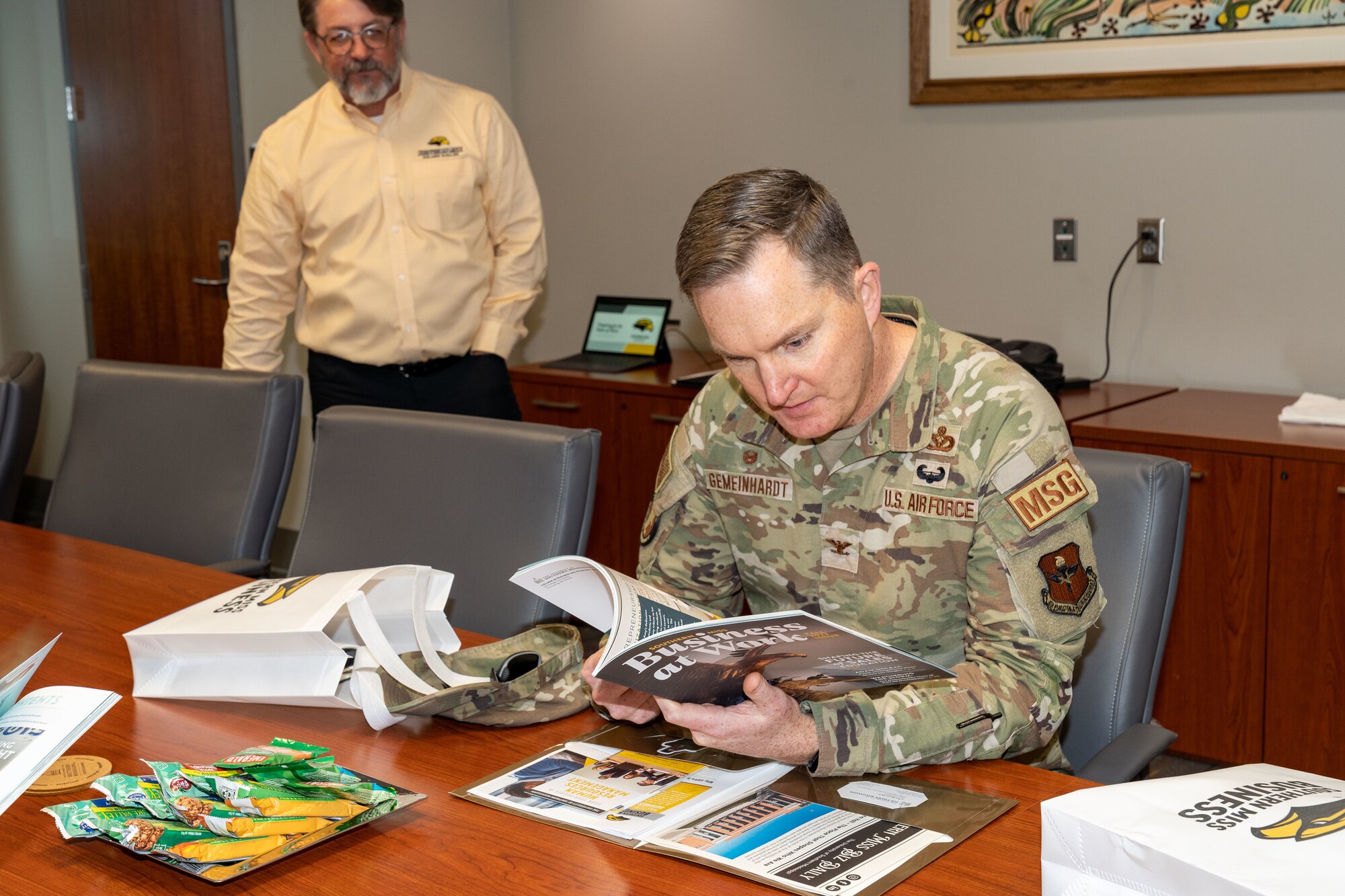 U.S. Air Force Col. Chad Gemeinhardt, 81st Mission Support Group commander, reads through the Southern Miss Business at Work magazine at the University of Southern Mississippi in Hattiesburg, Mississippi, March 1, 2024.