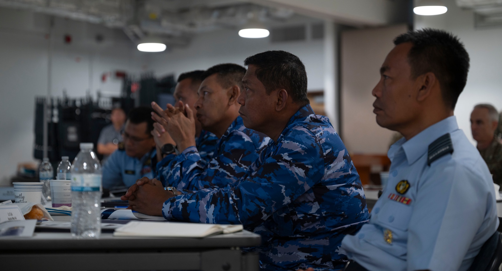 Members of the Indonesian Air Force listen to a brief during the Regional Air Domain Awareness Senior Leader Seminar on Andersen Air Force Base, Guam, Feb. 26, 2024. Throughout the seminar, leaders discussed air domain strategies, policies, terminology and also developed a network of Allies and partners that have a shared understanding of air domain awareness. (U.S. Air Force photo by Airman 1st Class Spencer Perkins)