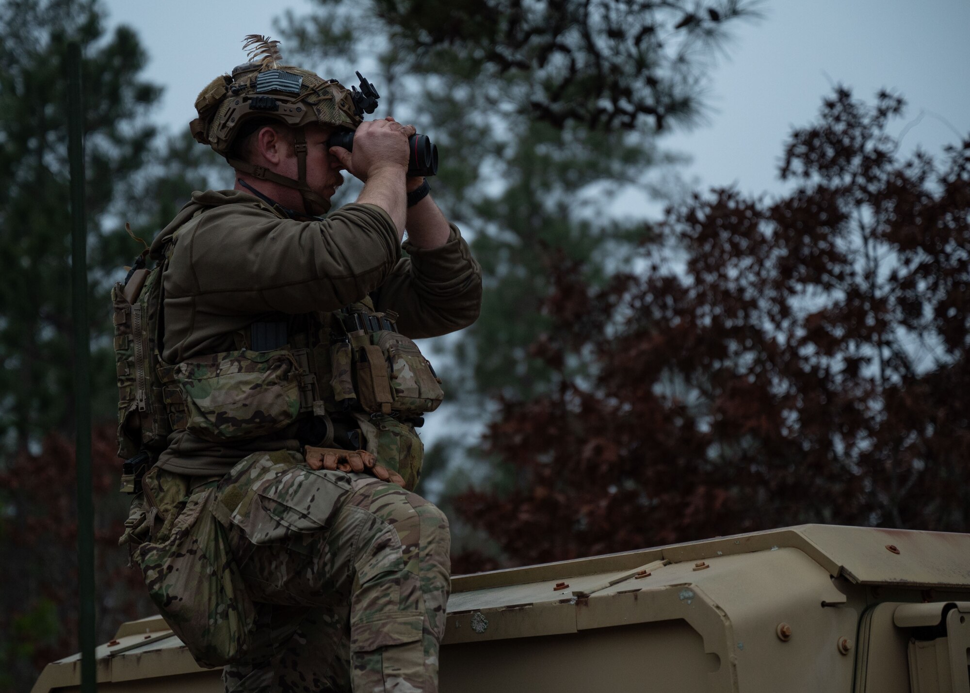 Man looks through binoculars.
