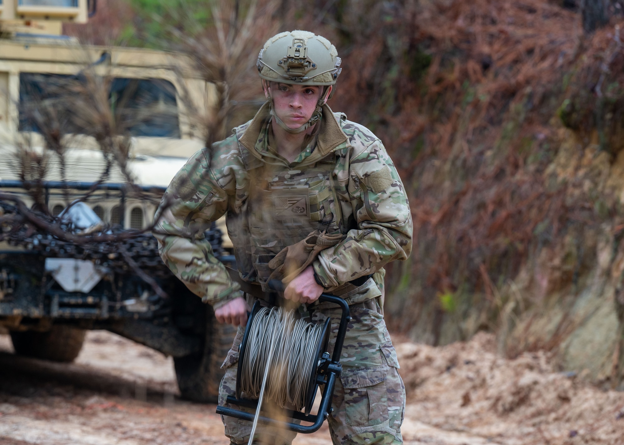 A man holds a reel of rope.