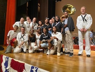 MAKO, Mauritius (March 2, 2024) The U.S. Naval Forces Europe-Africa Band pose for a photo with audience members following a performance at the Mahatma Gandhi Institute in Mauritius during exercise Cutlass Express 2024 (CE 24). Cutlass Express 2024, conducted by U.S. Naval Forces Africa and sponsored by U.S. Africa Command, increases the readiness of U.S. forces; enhances maritime domain awareness and collaboration among participating nations; and strengthens the capability of partner nations to combat piracy and counter illicit trafficking and illegal, unreported, and unregulated fishing. (U.S. State Department photo by Neddy Chanpin)