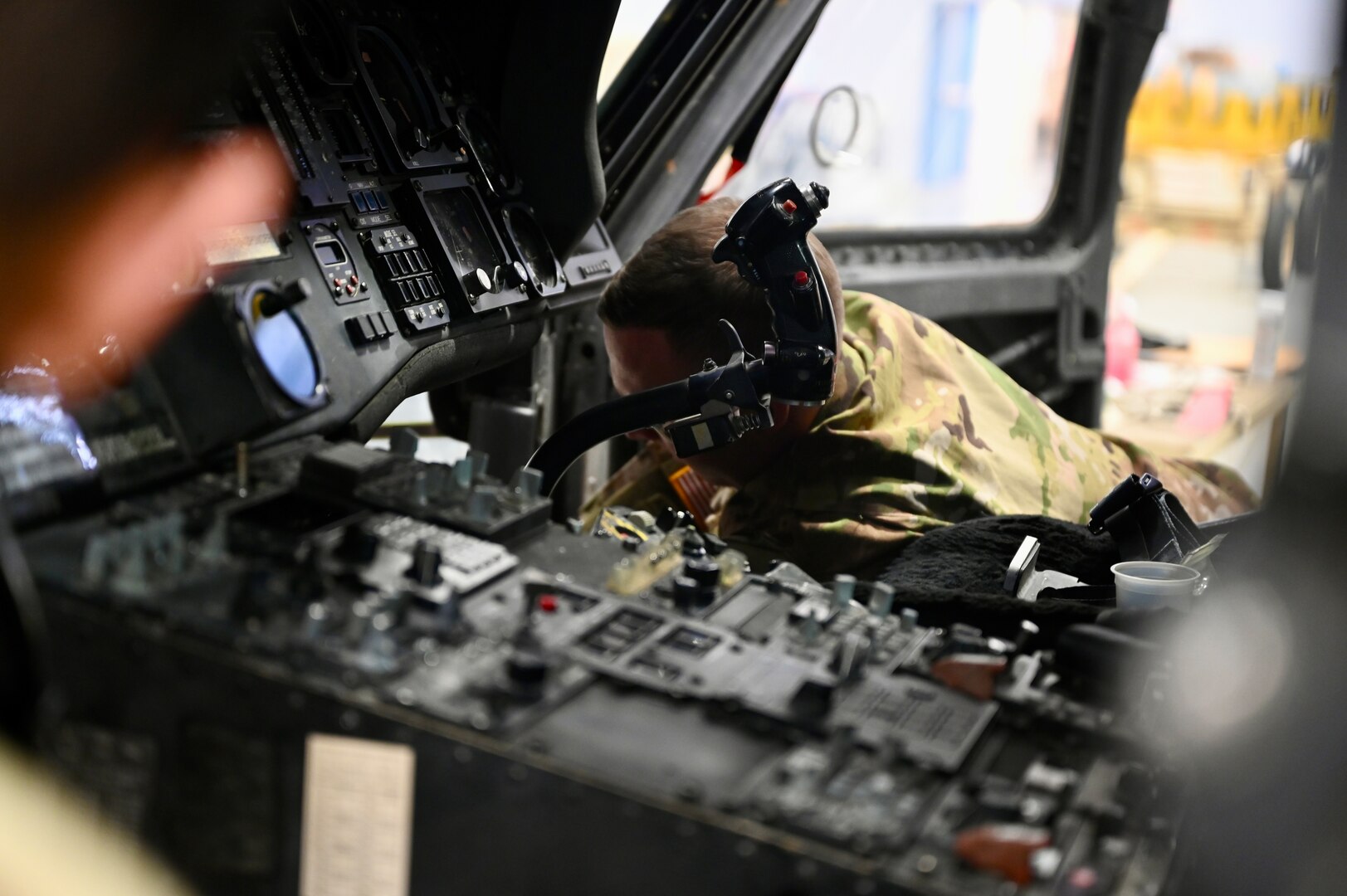 An avionic mechanic within District of Columbia Army National Guard Aviation inspects the interior of an aircraft at Davison Army Airfield, Feb. 3, 2024.  DCARNG Aviation is comprised of four different units with women visibly represented in all sections to include pilots, maintainers, supply, operations, administration, and flight paramedics.