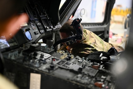 An avionic mechanic within District of Columbia Army National Guard Aviation inspects the interior of an aircraft at Davison Army Airfield, Feb. 3, 2024.  DCARNG Aviation is comprised of four different units with women visibly represented in all sections to include pilots, maintainers, supply, operations, administration, and flight paramedics.