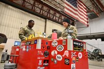 Cpl. Marquita Chase, avionic mechanic, District of Columbia Army National Guard Aviation, reviews a manual prior to maintenance on a UH-60 Blackhawk at Davison Army Airfield, Feb. 3, 2024.  DCARNG Aviation is comprised of four different units with women visibly represented in all sections to include pilots, maintainers, supply, operations, administration, and flight paramedics.