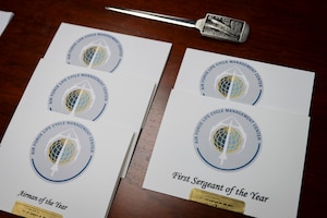 Photo of cards that show winners of AFLCMC awards.